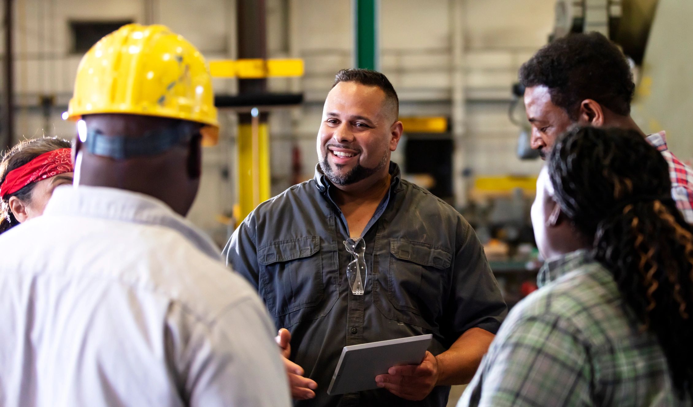 Factory leadership team meeting on the production floor